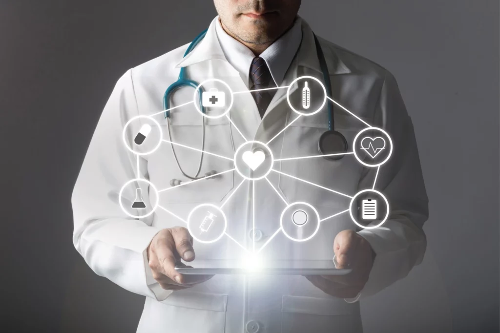 Medical person holding a tablet with a light shining up with a ring of icons